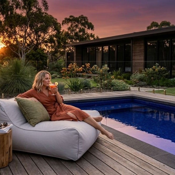 Bean Bag Bliss - lady sitting on a Chill UV Lounger enjoying a sunset cocktail.
