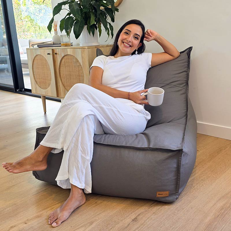 A modern home interior featuring the Stylish Mocha Single Boss bean bag chair by Mooi Living with model seated.