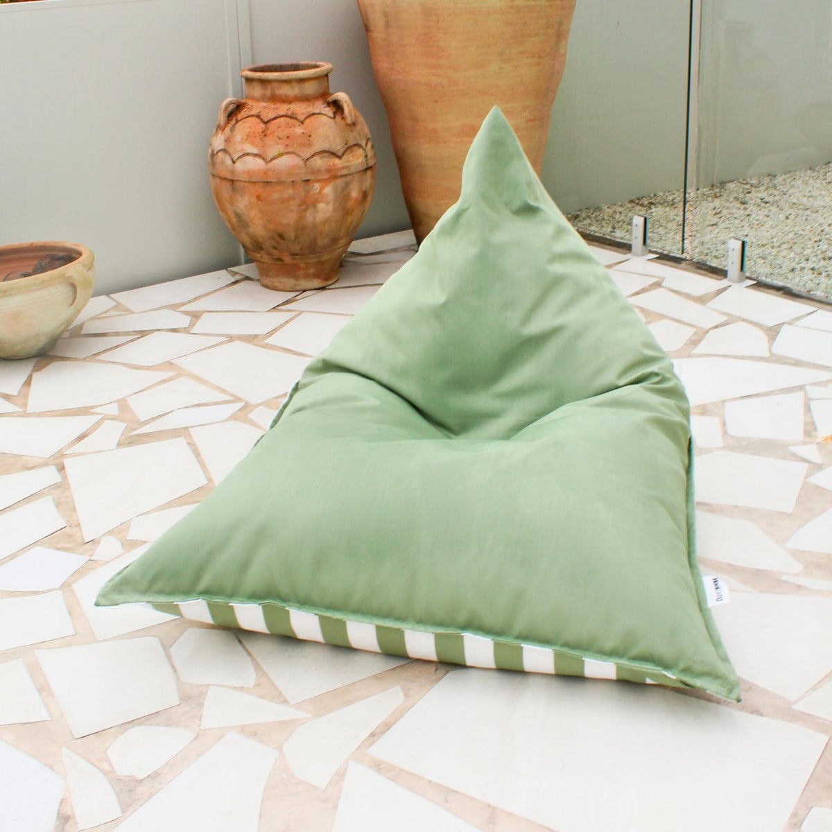 Mooi Living Sage Green reversible triangle outdoor bean bag showing its sage green and white striped side, MOREVSTRIBB-GRE