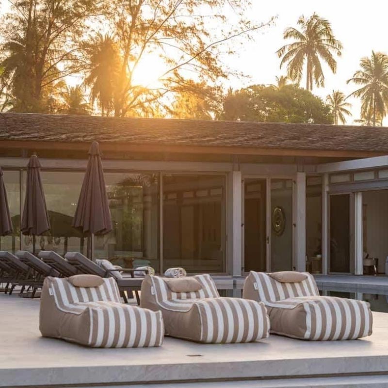 Three Taupe Stripe Cojelo Suave Sunloungers, outdoor bean bag by Mooi Living, placed side by side poolside at Villa Essenz Natai, customer photo by @Villa_essenza_natai.