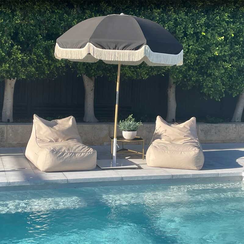 Customer pic by Kate Farmer of two of our Taupe Lachlan Loungers outdoor bean bag by Mooi Living by her poolside with an umbrella