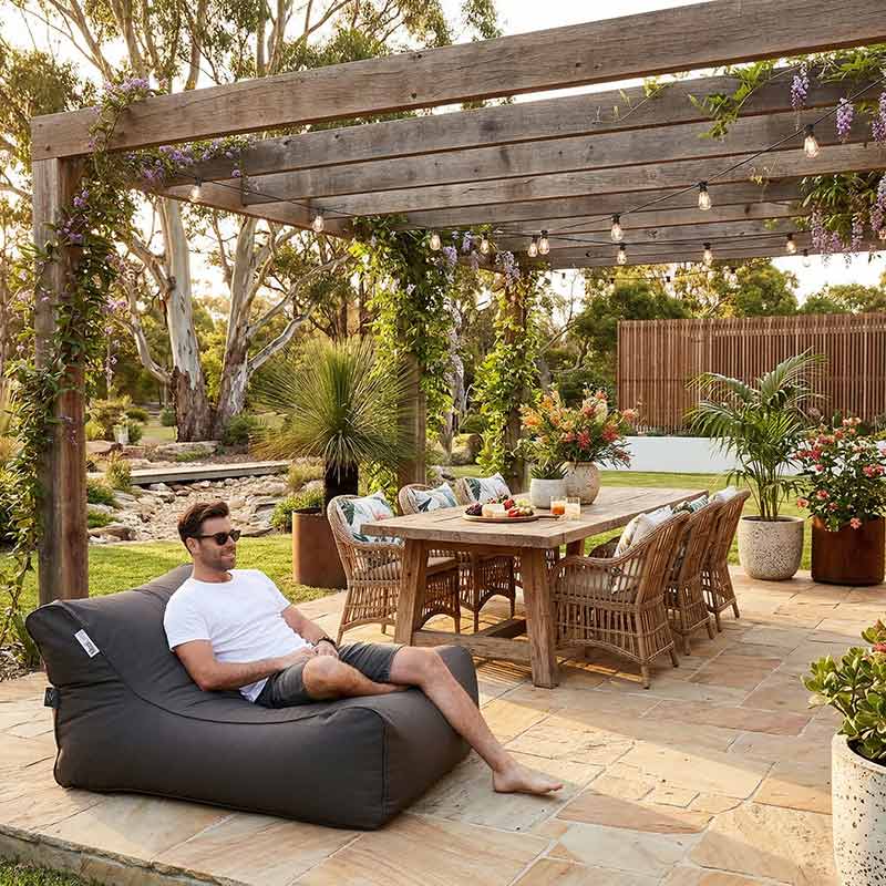 Lifestyle Image - featuring an Oyster Black Chill UV Lounger placed in an Australian Patio.