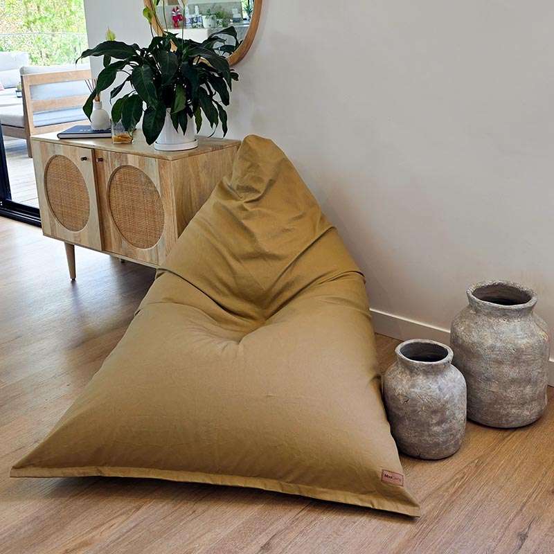 Tan oversized Cotton Canvas Triangle Bean Bag Chair by Mooi Living positioned in a contemporary interior with natural finishes.