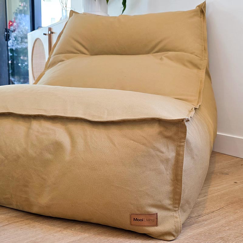 Oversized Tan cotton canvas Single Boss indoor seating styled on timber flooring.