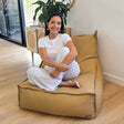 Mooi Living Tan Single Boss Bean BAg lounge-style seating positioned in a softly lit living space with model