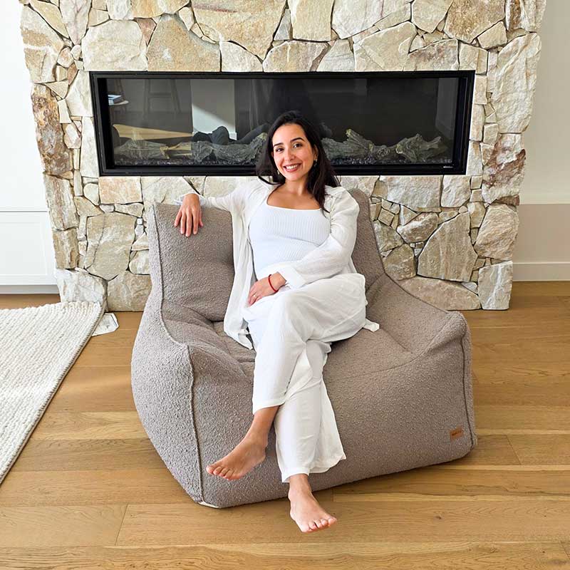 Taupe Bouclé Serena Armchair Bean Bag by Mooi Living styled in a modern living room, woman seated.