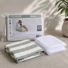 Folded Outdoor Stripe Bora Bora chair bean bag cover in Sage green and white stripe and inner bag in a Mooi Living packaging.