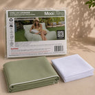 Folded Chill uv lounger bean bag cover in Sage green solid with white piping and inner bag in a Mooi Living packaging.