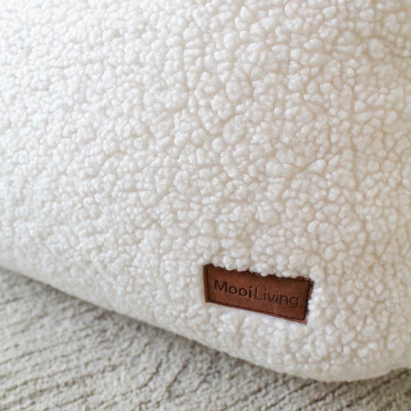 Close-up fabric photo of the Hallie Bean Bag Chair indoor bean bag by Mooi Living in Cream with a brown 'MooiLiving' label.