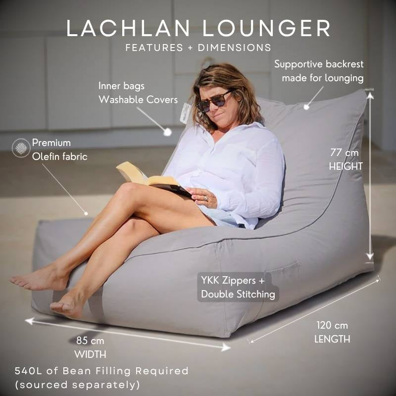A woman sits on a Lachlan Sunlounger in Pumice colour, reading a book. The image includes text callouts showing dimensions (77 cm height, 85 cm width, 120 cm length), features like YKK zippers and double stitching, and mentions 540L of bean filling.