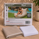 Folded Lachlan lounger bean bag cover in Taupe with white piping and inner bag in a Mooi Living packaging.