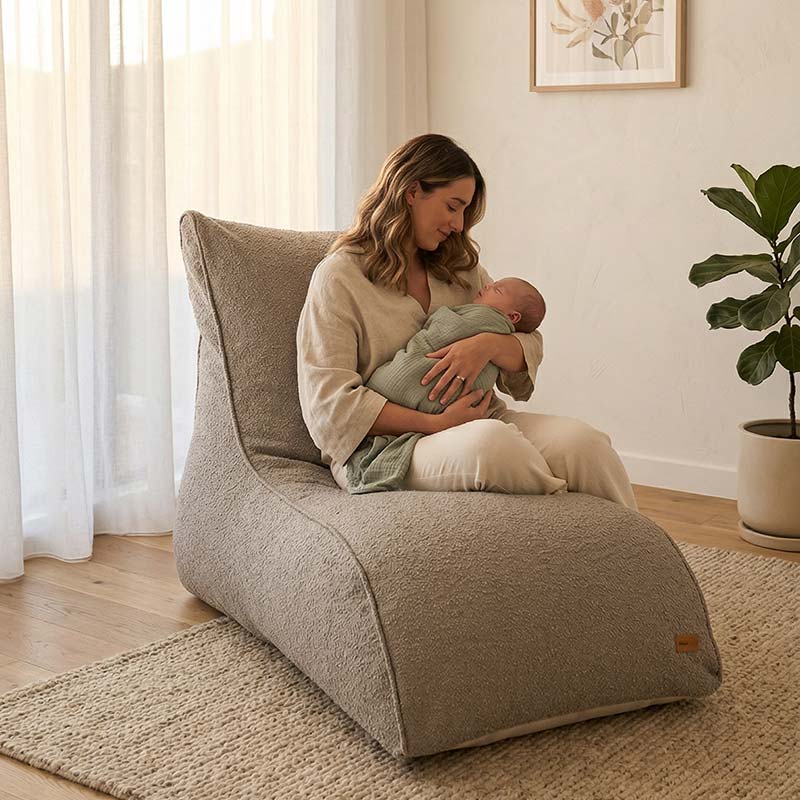 New mother holding her newborn baby while seater on a Taupe Boucle Indoor Bean Bag Lounger indoor Bean Bag by Mooi Living