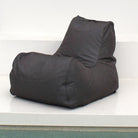 An Oyster Black Outdoor Olefin fabric bean bag chair with a high backrest, sitting on a white platform against a white wall, MOBORABB-OYSBLA