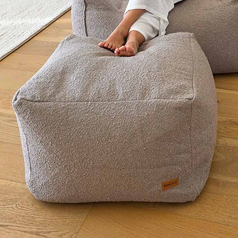 Taupe bouclé Serena ottoman by Mooi Living with textured upholstery.