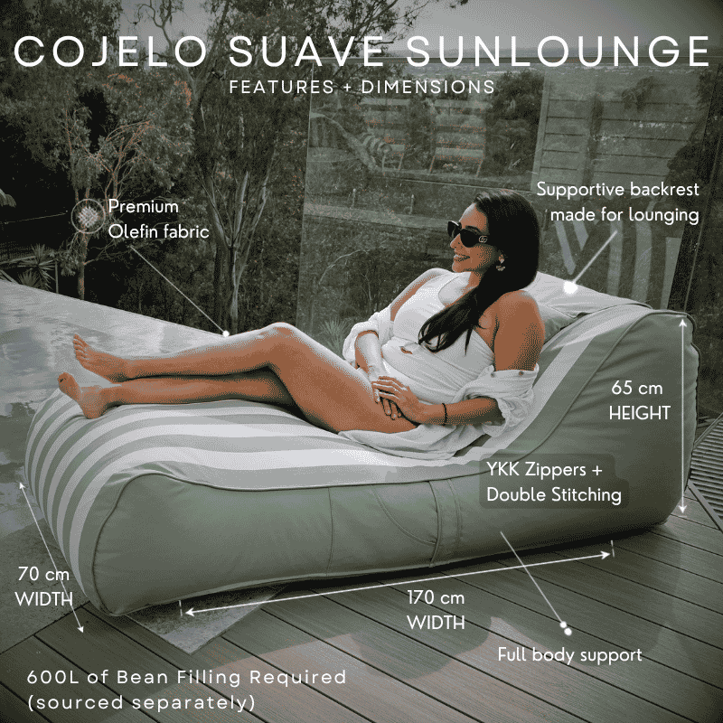 A woman reclines on an outdoor bean bag lounge chair labeled 'COJELO SUAVE SUNLOUNGE' with feature callouts and dimensions including 65 cm height, 70 cm width, and 170 cm width. The lounger is sage green and white striped, set on a wooden deck beside a pool with a glass wall and trees in the background.
