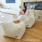 Cream Bouclé Serena Armchair Bean Bag with coordinating ottoman indoor bean bag by Mooi Living, styled in a modern interior.