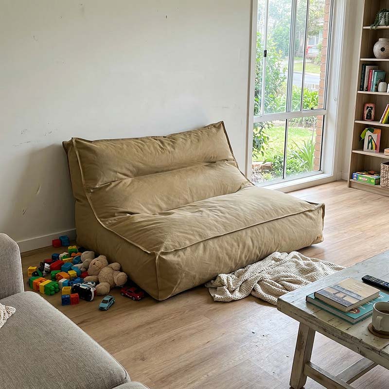 Photo shared by a customer. Cotton Double Boss indoor bean bag by Mooi Living in Tan, in a living room with toys and a coffee table.