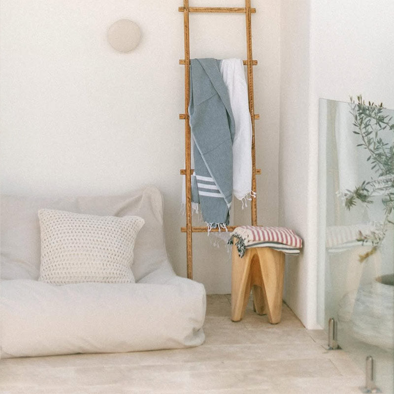 Natural Chill UV Lounger by Mooi Living styled outdoors with a wooden ladder alongside, customer photo by @hudsonyard_design.